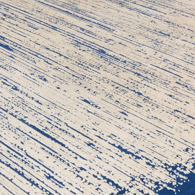 Beige and blue abstract pattern area rug with linear textured design