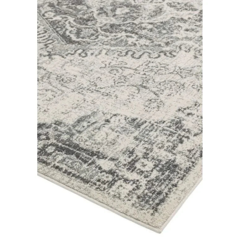Grey and cream patterned area rug with distressed vintage design, corner view