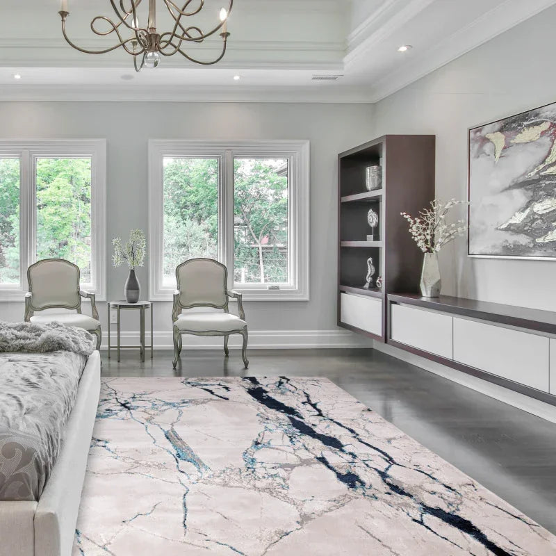 Modern bedroom with marble pattern rug, accent chairs, and decorative shelving unit