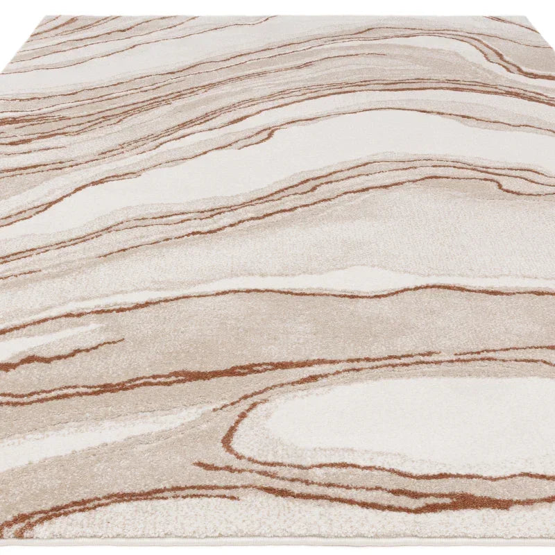 Beige and cream area rug with abstract wave pattern and soft textured pile