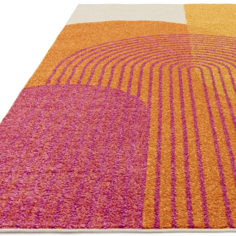 Modern area rug with orange and pink geometric pattern, close up of textured surface
