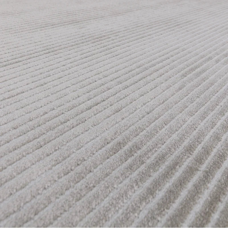Closeup of light grey corduroy sofa fabric showing soft ribbed texture