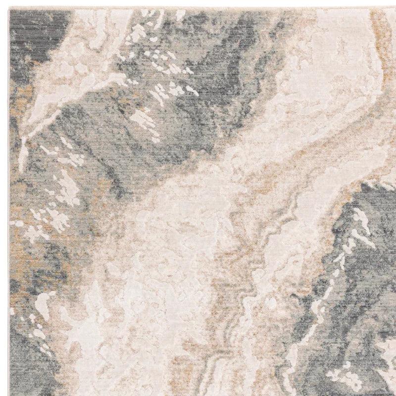 Abstract area rug with grey, beige, and cream swirled pattern