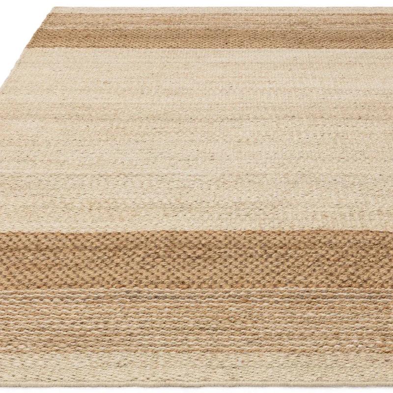 Natural jute rug with beige and tan horizontal stripes, close-up of woven texture