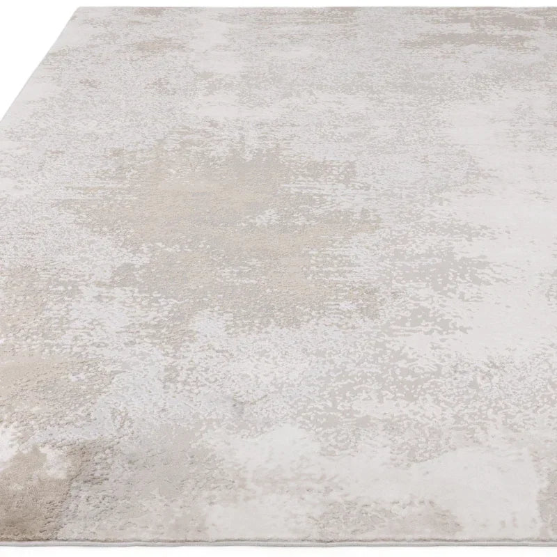 Modern beige area rug with subtle textured pattern on flat surface