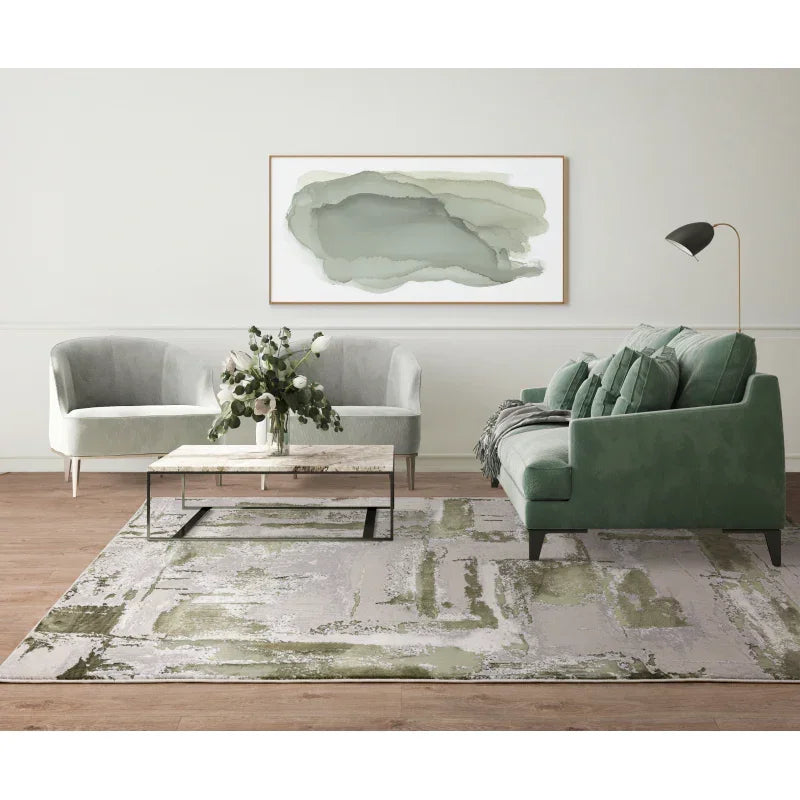 Modern living room with green sofa, grey armchair, abstract rug and marble coffee table