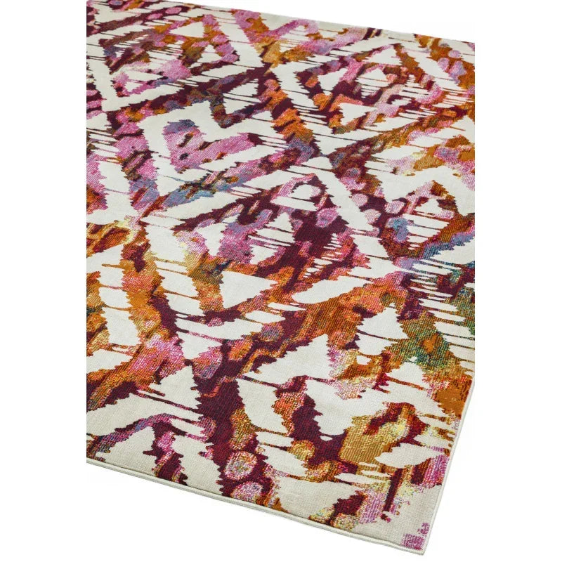Abstract patterned area rug with orange, pink, and purple on a cream background