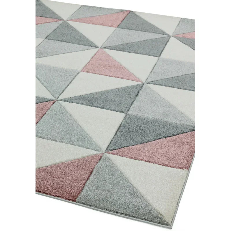 Geometric rug with pink, grey, and cream triangles in a modern pattern