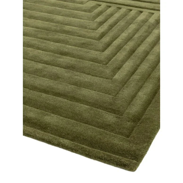 Green geometric wool rug with raised square pattern and soft textured surface