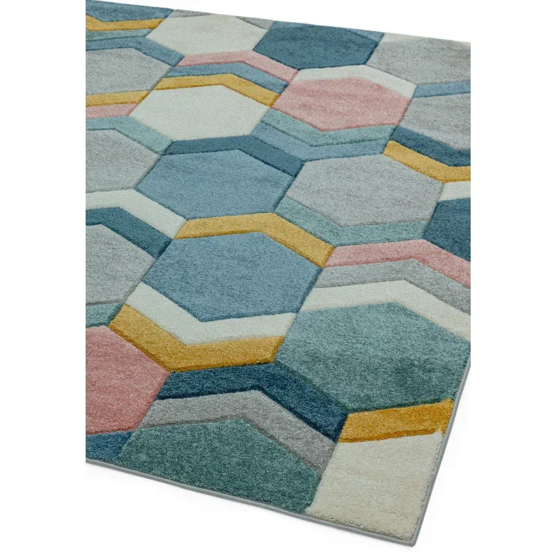 Geometric rug with blue, grey, mustard, and pink hexagon pattern on soft pile