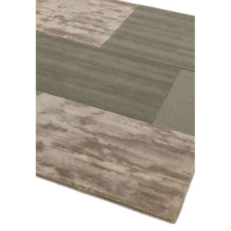 Modern area rug with abstract beige and grey block pattern, close-up corner view