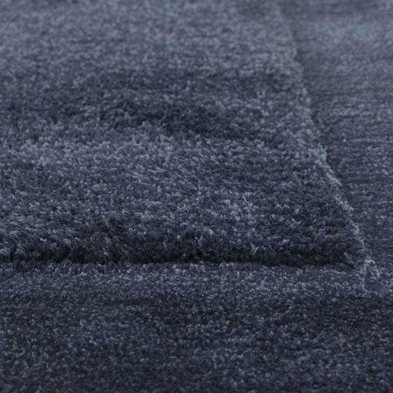 Close up of grey textured rug fibers and geometric pattern