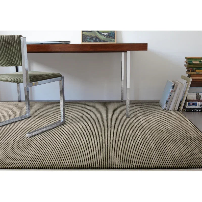 Modern ribbed beige rug in home office with contemporary chair and wooden desk