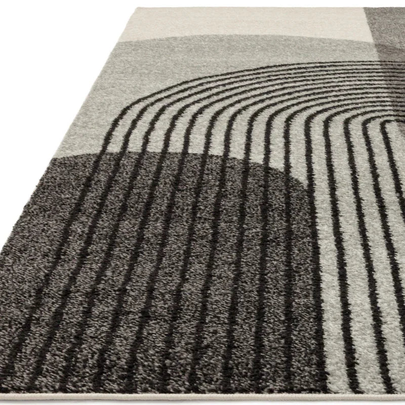 Modern area rug with grey and black abstract geometric pattern and textured lines