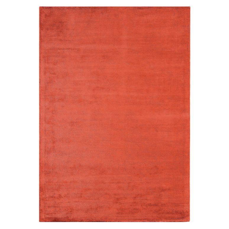 rectangular orange area rug with subtle textured pattern