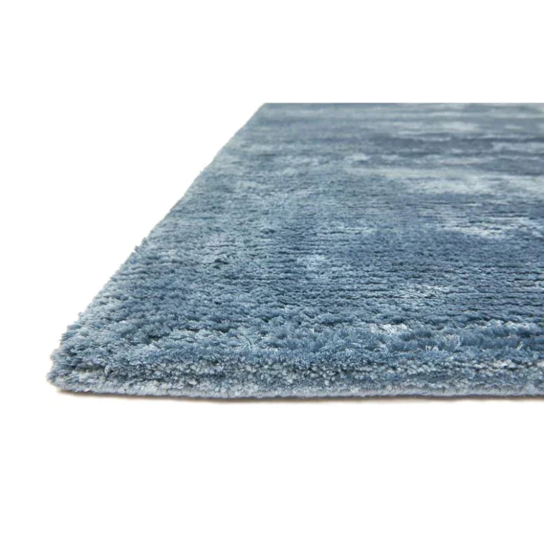 Blue shaggy rug closeup showing thick soft pile texture