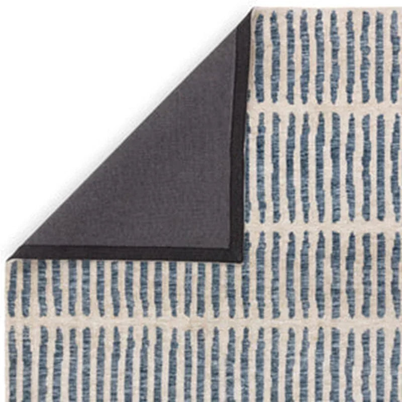 Blue and cream patterned throw blanket with dark grey reverse corner shown