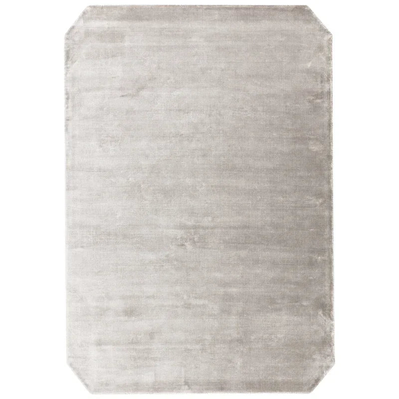 Light grey rectangular area rug with subtle texture and chamfered corners
