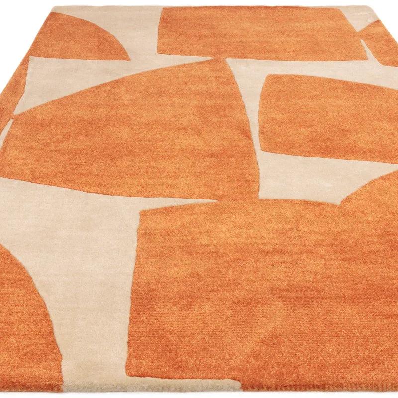 Modern orange and cream geometric area rug with abstract shapes
