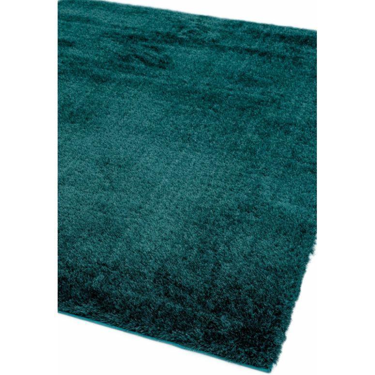 Teal shaggy area rug with soft textured pile, close-up of corner detail