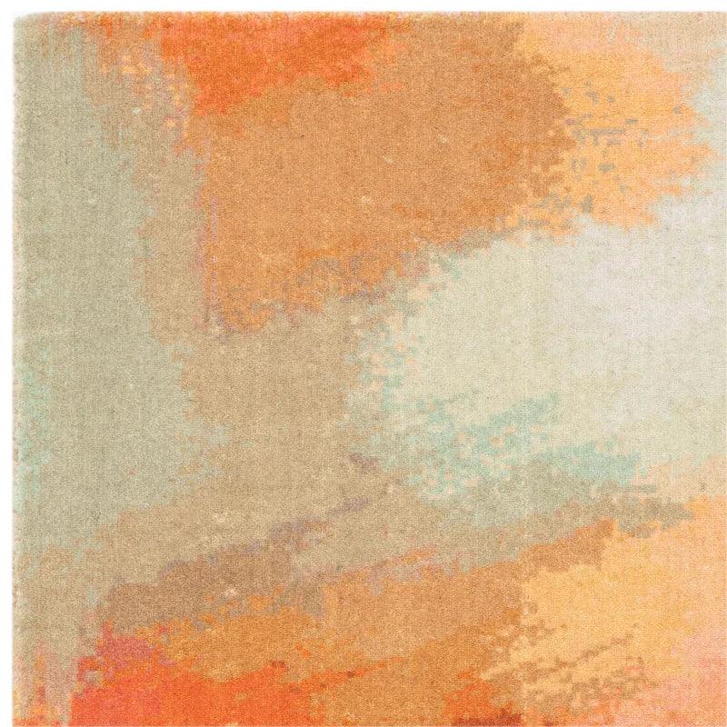 Modern abstract area rug with orange, beige, and light blue pattern