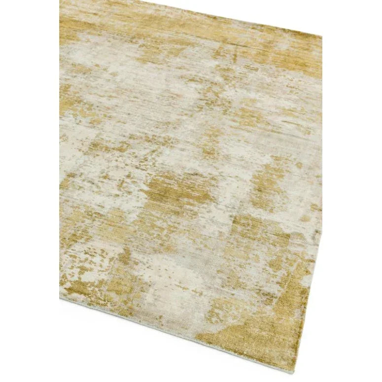 Beige and gold abstract area rug with textured pattern, angled view of corner