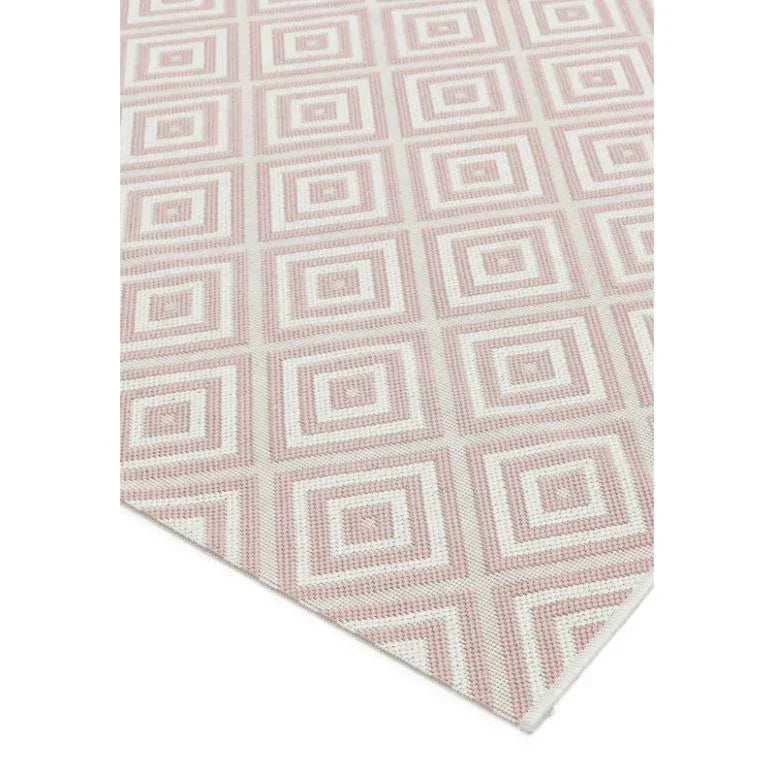 Pink geometric pattern rug with square design, close-up corner view highlighting woven texture