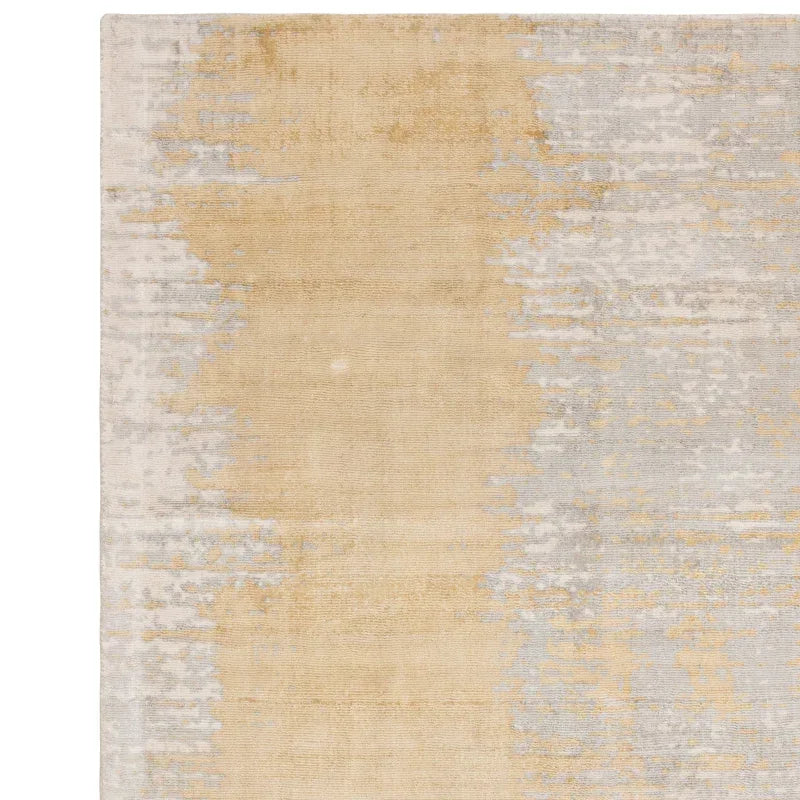 Beige and grey abstract area rug with textured pattern and soft gradient design