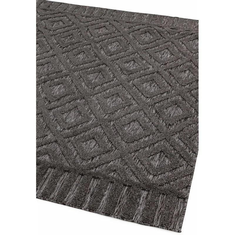Dark grey geometric pattern rug with textured diamond design and striped border detail