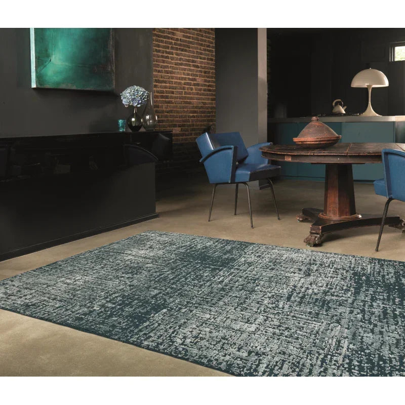 Blue patterned area rug on concrete floor in modern dining room with brick wall