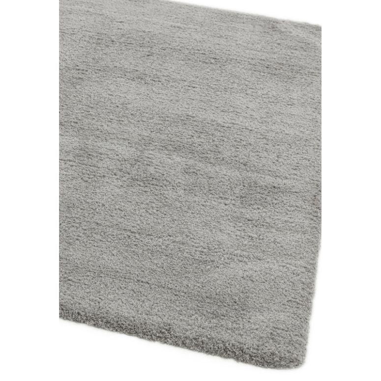 Light grey shaggy rug corner close-up showing soft texture and thick pile