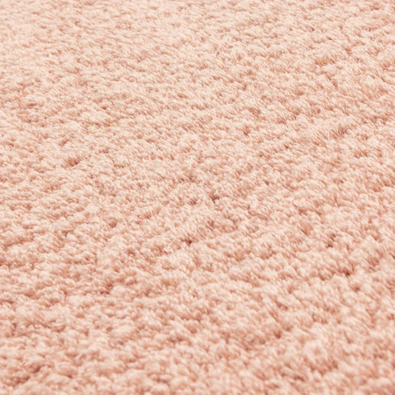 Close view of blush pink shaggy rug texture and soft pile