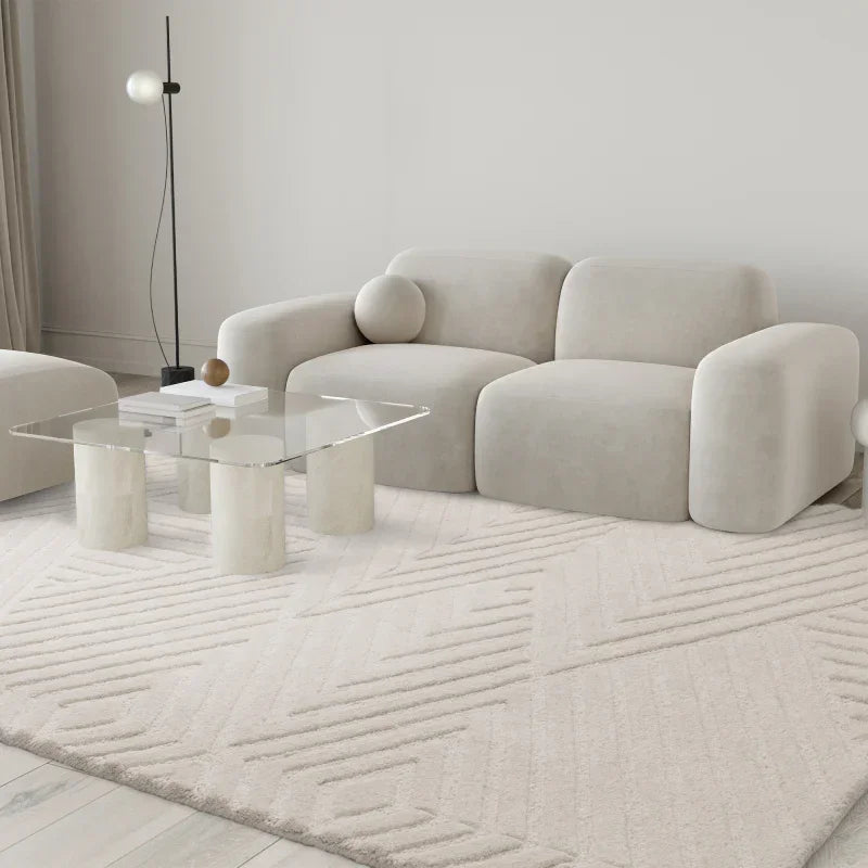 Contemporary cream sofa set with glass coffee table on textured beige living room rug