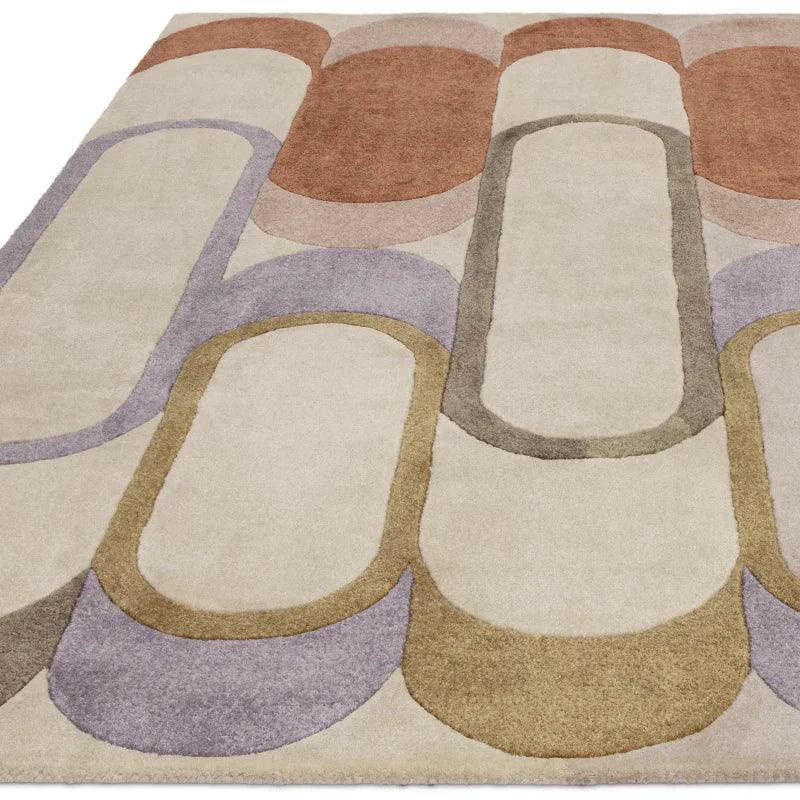 Modern area rug with abstract oval patterns in beige, brown, purple, and olive tones