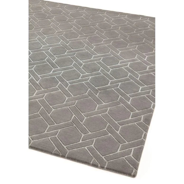 Grey geometric pattern rug with raised hexagonal design on soft fabric
