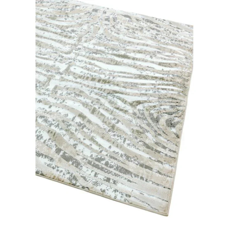 Beige and cream patterned area rug with subtle abstract design, corner view