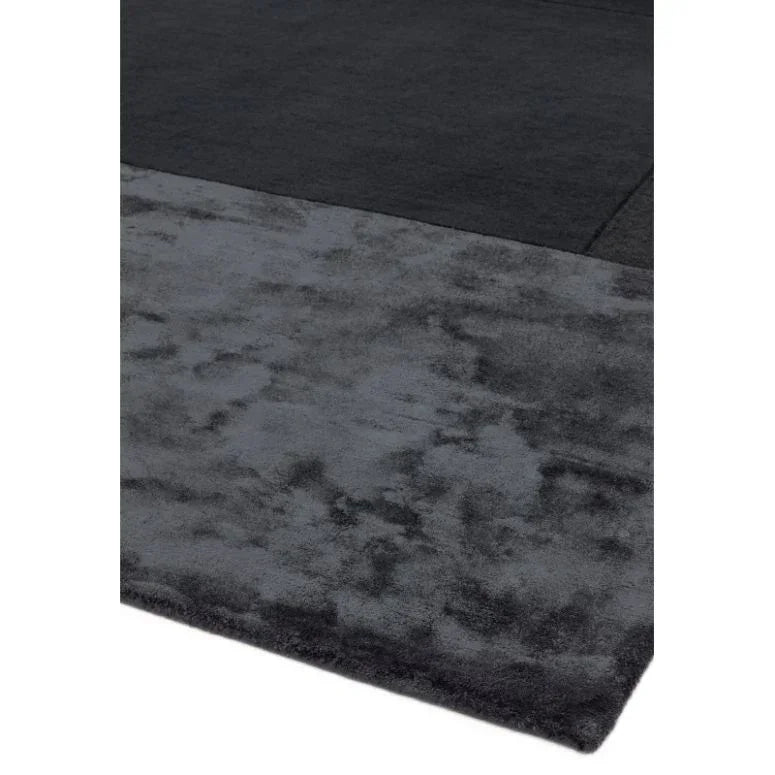 Modern dark grey area rug with plush texture and rectangular design