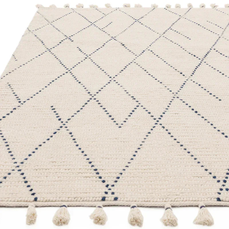 Cream area rug with blue geometric lines and corner tassels