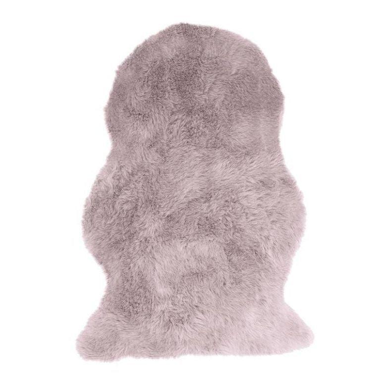 Blush pink sheepskin rug with soft fluffy texture on white background