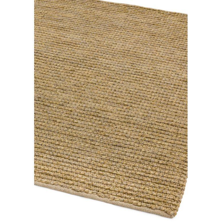 Natural jute rug closeup showing textured weave and finished corner
