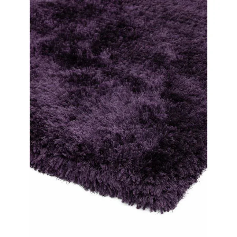 Plush purple shaggy rug close-up showing thick soft pile and textured surface