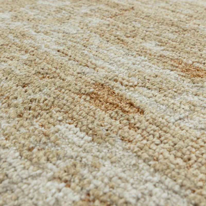 Closeup of beige woven rug texture with subtle pattern detail