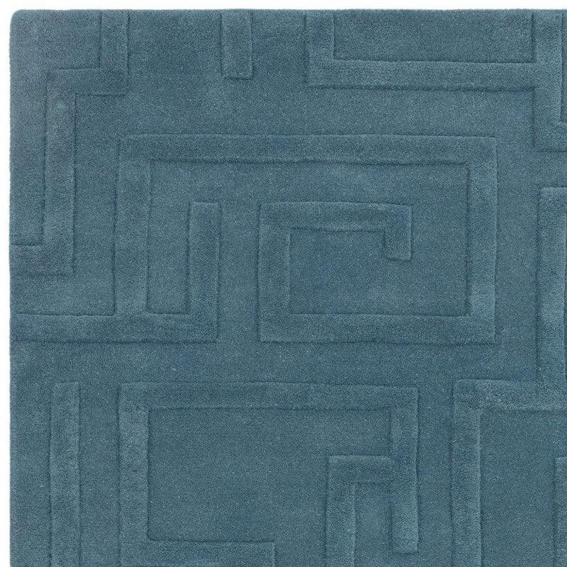 Blue geometric pattern rug with raised textured squares, close-up of wool material