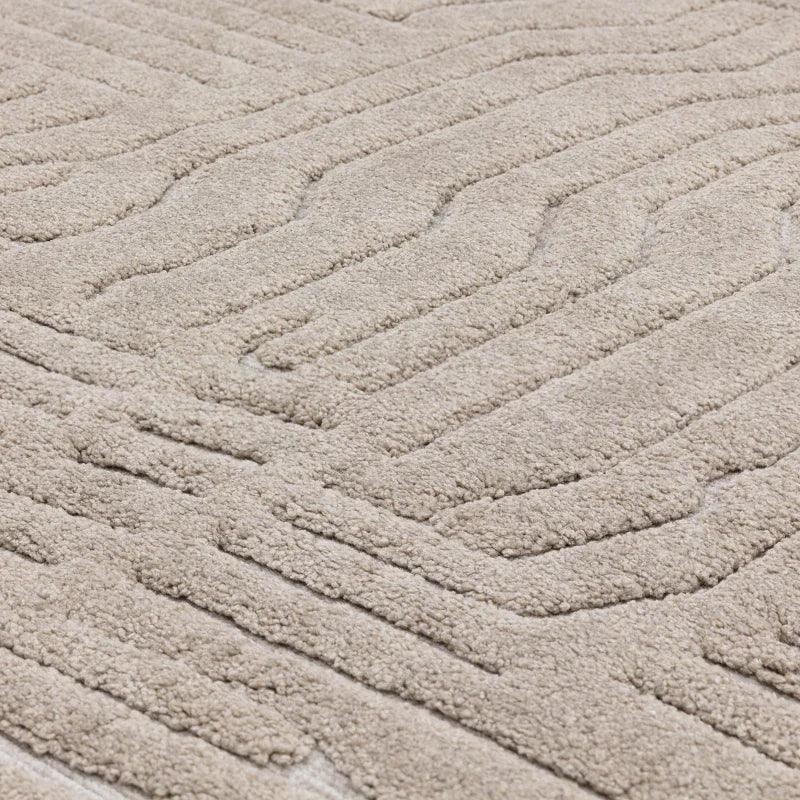 Beige textured area rug with raised geometric pattern and soft pile detail
