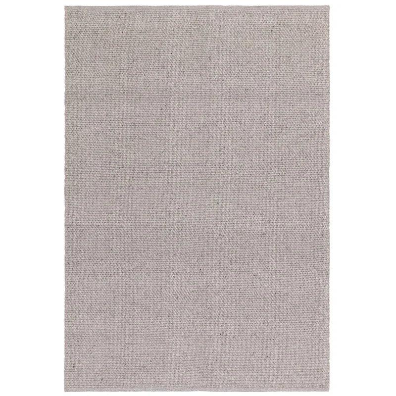 Rectangular light grey woven rug with subtle textured pattern