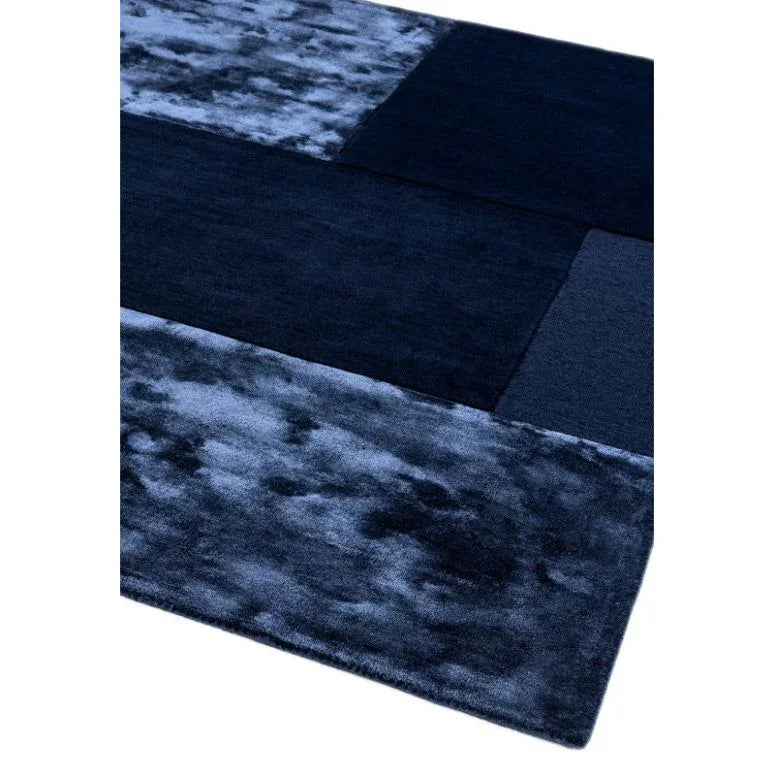 Navy blue geometric area rug with plush texture and abstract pattern blocks