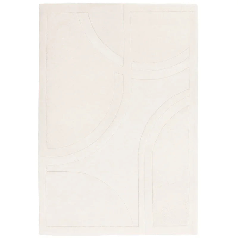 Cream area rug with raised geometric pattern and soft texture