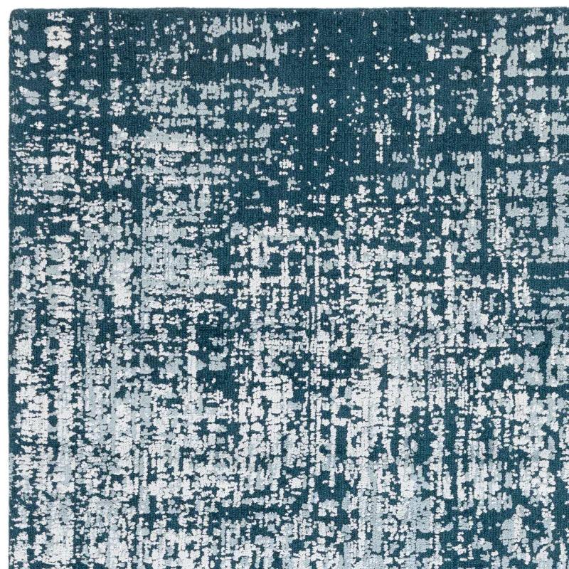 Blue and white abstract patterned rug with textured finish, top corner view
