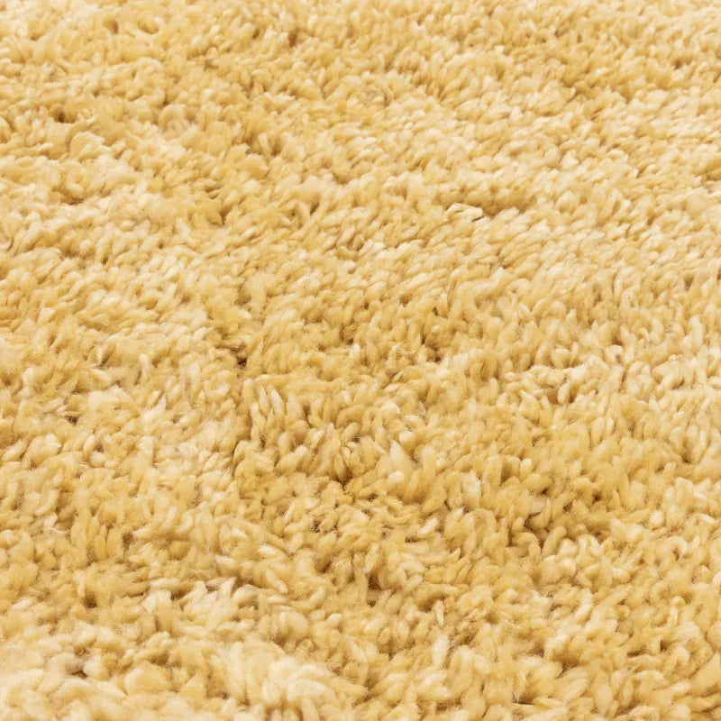Close-up of beige shaggy rug texture and fibers