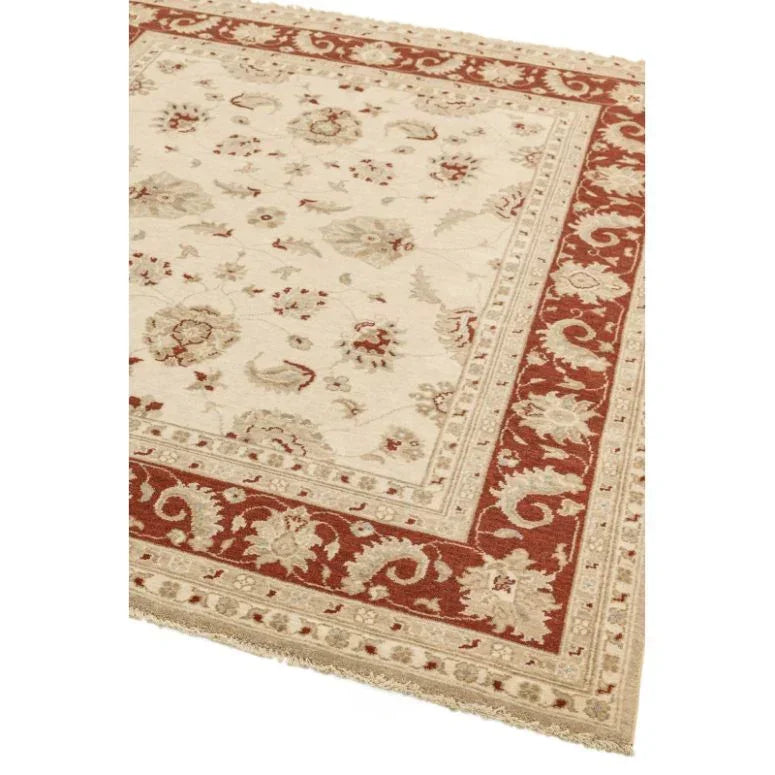 Traditional area rug with cream center and red floral border pattern